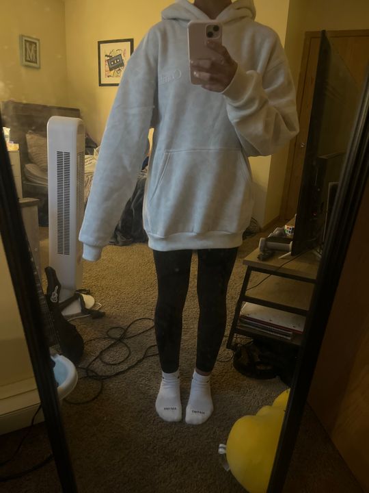Customer Maya wearing an oversized light blue Snow Leopard hoodie