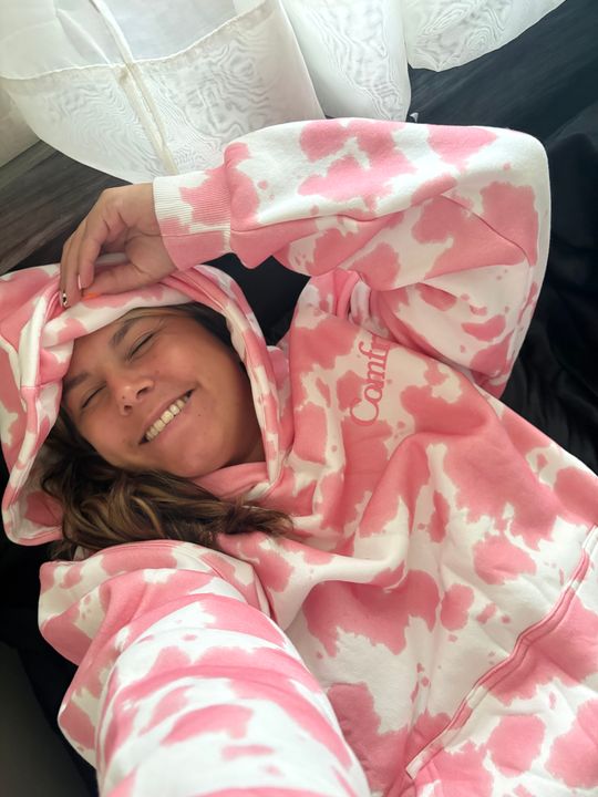 Customer Taylor wearing a pink and white Strawberry Milk hoodie set