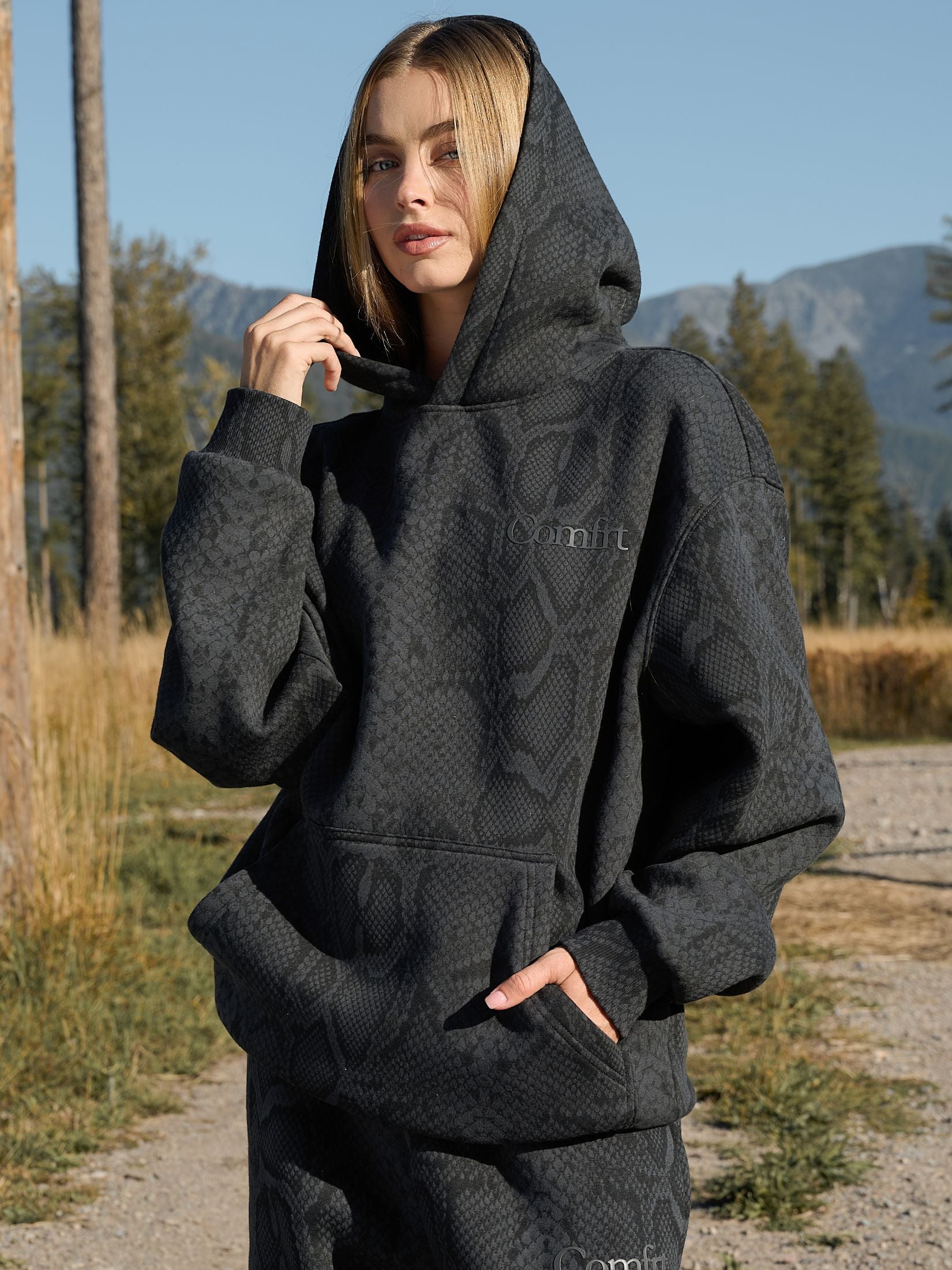 Model wearing an oversized black hoodie